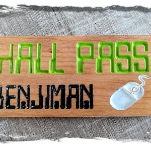May include: A wooden hall pass with the name "BENJAMIN" in black and "HALL PASS" in green. A small, light blue mouse graphic is on the right. A black lanyard is attached to the pass.