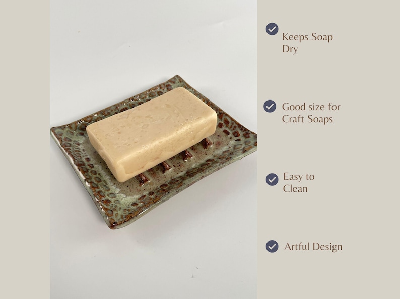 A rectangular Seafoam Green Soap Dish, with a bar of soap. Wording shows Features as follows: Keeps soap dry, Good size for craft soap, Easy to clean, and Artful design.