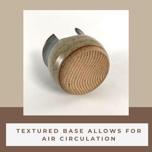 A piece of pottery with wiggle wire cut marks across the bottom to show that the texture marks allows for air circulation.