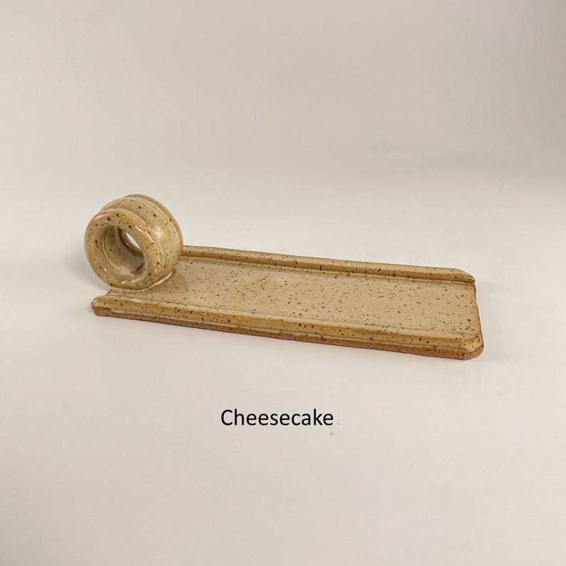 May include: A trio of speckled ceramic mugs in cream, light grey, and dark grey. These mugs have a matte finish and a minimalist design. Ideal for enjoying tea or coffee.