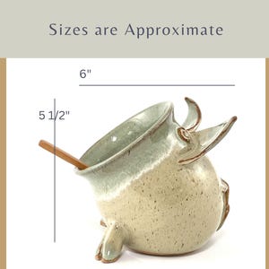 A Seafoam Green Salt Pig with wooden spoon showing measurements:
6" long and 5 1/2" tall.
Sizes are approximate.