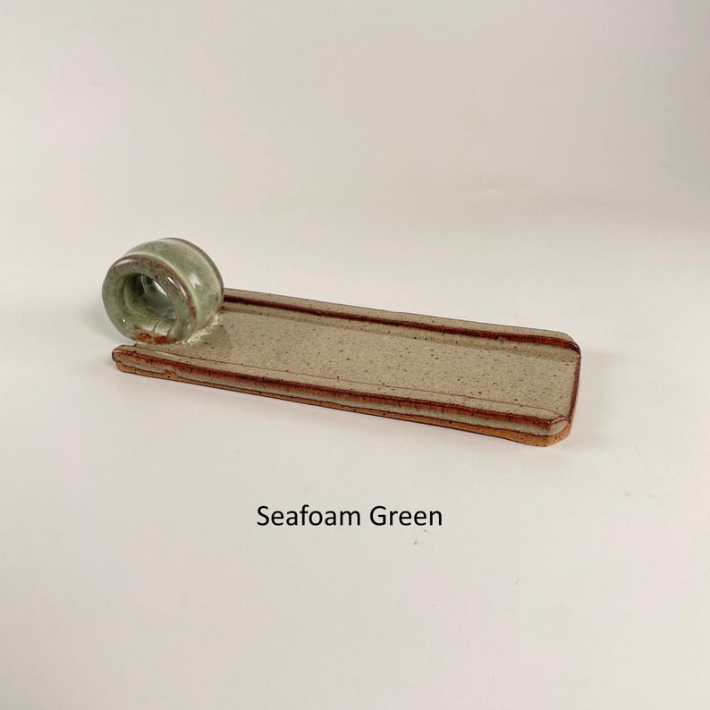 May include: A set of three ceramic mugs with a speckled, matte finish in cream, light grey, and dark grey. Each mug has a minimalist design, ideal for coffee or tea.