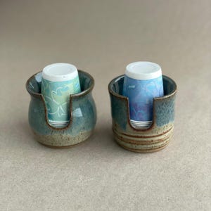 Two Cup Dispensers showing both the Belly Style and the Square Style filled with Disposable cups, ready for use.