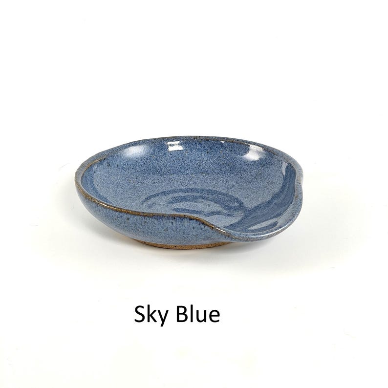 Sky Blue handcrafted spoon rest, shallow round shape with notch for spoon handle, formed on a potter's wheel.