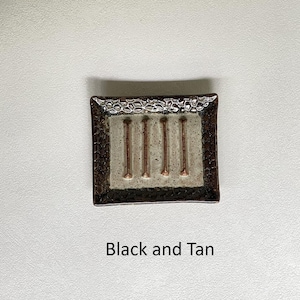A Black and Tan Soap Dish.