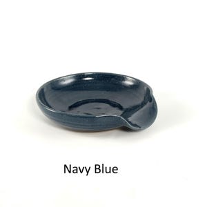 Navy Blue handcrafted spoon rest, shallow round shape with notch for spoon handle, formed on a potter's wheel.