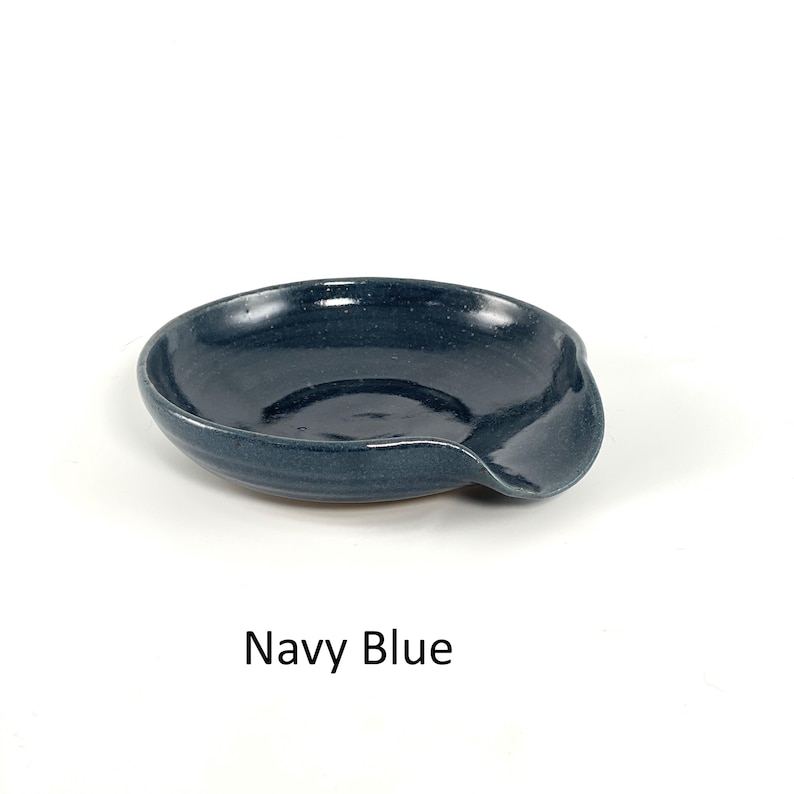 Navy Blue handcrafted spoon rest, shallow round shape with notch for spoon handle, formed on a potter's wheel.