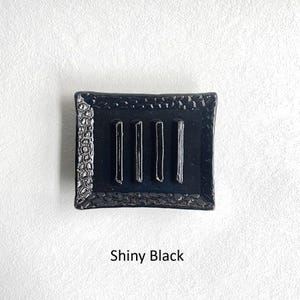 A Shiny Black Soap Dish.