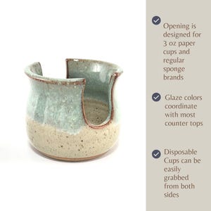 Showing a Seafoam Green Cup Dispenser with text describing the features of this product, including: The opening size for 3 oz paper cups and regular sponges, glaze colors that coordinate with most counter tops, and the ease of grabbing a disposable cup.