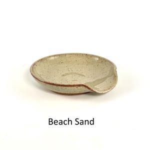 Beach Sand handcrafted spoon rest, shallow round shape with notch for spoon handle, formed on a potter's wheel.