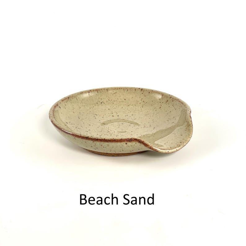 Beach Sand handcrafted spoon rest, shallow round shape with notch for spoon handle, formed on a potter's wheel.