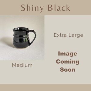 May include: A shiny black ceramic mug with a rounded body and a curved handle. The text on the image reads Shiny Black, Extra Large, Medium, and Image Coming Soon. The mug has a smooth, reflective surface and a visible base rim.