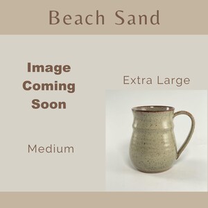 Showing places for two Beach Sand Banded Belly Mugs, one sized Medium and the other sized Extra Large. The Medium is labeled Image coming soon The Extra Large is showing.