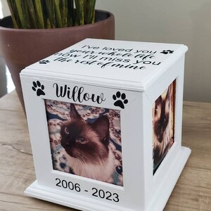 May include: White wooden box with a photo frame and a paw print design. The frame contains a photo of a cat. The box has the text "I've loved you your whole life now I'll miss you the rest of mine" and "Willow" on the front. The bottom of the box has the dates "2006 - 2023".