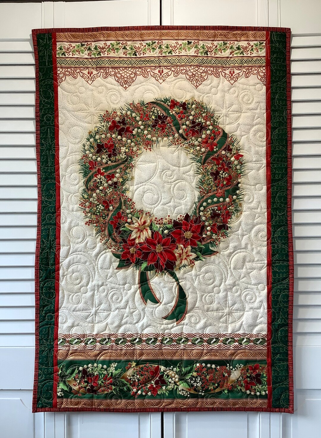 Quilted Christmas Wreath Wall Hanging in Red Green and Gold With Poinsettias Ribbons Holly