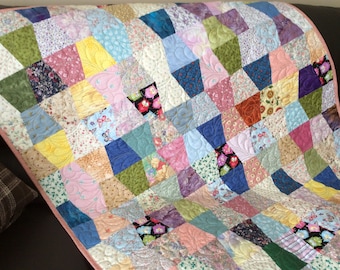 Tumbler block lap quilt in scrappy multi colors, quilted with feathers, crib size quilt or can be used as a table cloth or picnic blanket