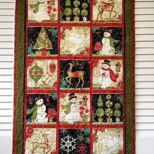 Christmas quilted wall hanging with Xmas trees, snowmen, reindeer, ornaments and doves in red green black and cream. Table runner,