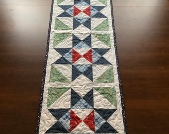 Quilted star table runner in red white and blue with green accents,  wall hanging or coffee table mat or bed runner