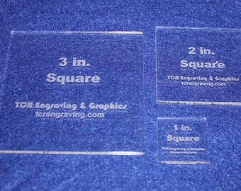May include: Three clear acrylic squares with the text "3 in. Square", "2 in. Square", and "1 in. Square" printed on them. Each square includes the text "TOR Engraving & Graphics tcrengraving.com".