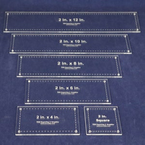 May include: Set of six clear acrylic rulers for quilting and sewing. The rulers are marked with measurements in inches, including 2 x 12 inches, 2 x 10 inches, 2 x 8 inches, 2 x 6 inches, 2 x 4 inches, and a 2-inch square.