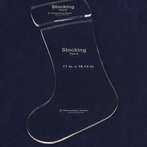 May include: Two clear plastic stocking stencils, one labeled "Stocking Part A" and measuring 11 inches by 18.14 inches, and the other labeled "Stocking Part B".