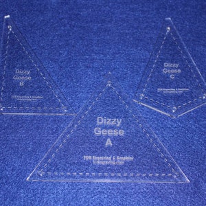 May include: Three clear plastic triangle quilting templates labeled "Dizzy Goose A", "Dizzy Goose B", and "Dizzy Goose C".