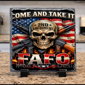 May include: A decorative slate featuring a skull with the words "2ND AMENDMENT" on its forehead, set against an American flag design. The phrase "COME AND TAKE IT" is at the top, with "FAFO" at the bottom.