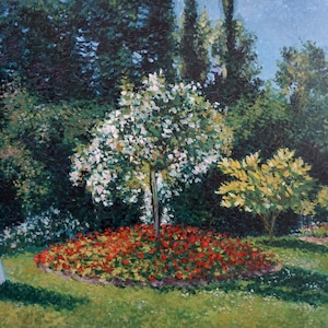May include: A woman in a white dress and hat walks through a garden with a white tree in the center. The garden has red flowers and green grass.
