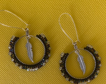 Hoop earrings with beads, crystals and a feather