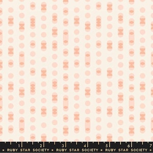 May include: A white fabric with a repeating pattern of pink circles and pink ovals. The ovals are made up of two half circles.