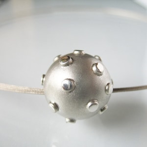 Elegant necklace with silver ball, hand-forged