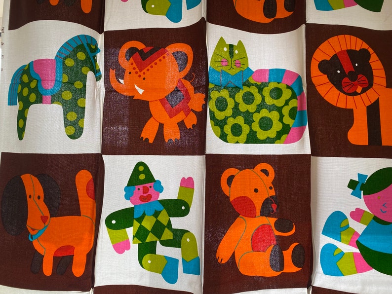 May include: A colorful fabric with a repeating pattern of various animal illustrations. The animals include a horse, elephant, cat, lion, dog, clown, bear, and a girl. The fabric is brown, orange, green, blue, pink, and white.