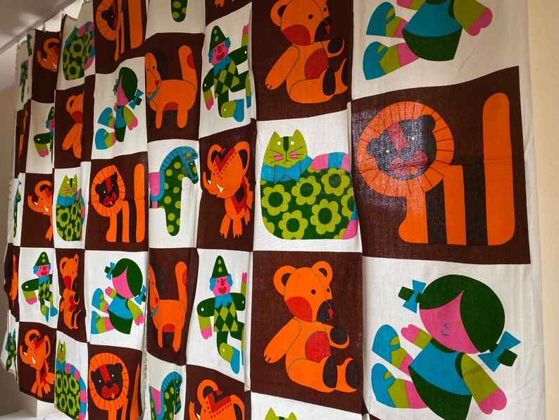 May include: A brown and white fabric with a repeating pattern of colorful animals and figures. The animals include a lion, a cat, a bear, and a horse. The figures include a clown and a girl.