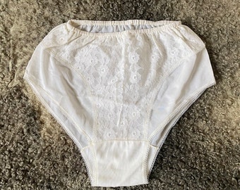 May include: White lace underwear with a floral pattern. The underwear has a high waist and a full coverage back.
