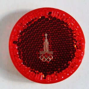May include: Red reflective safety sticker with the Olympic rings and the Moscow 1980 Olympic logo.