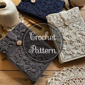 Könnte beinhalten: Drei rechteckige Häkelhüllen in Dunkelblau, Anthrazit und Creme, jeweils mit einem komplexen Blattmuster, einem Knopfverschluss und einer Lasche. Der Text "Crochet Pattern" ist über den Objekten zentriert, daneben liegt ein Garnknäuel.