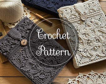 May include: Three rectangular crochet covers in dark blue, charcoal grey, and cream, each featuring an intricate leaf-like pattern, a button closure, and a strap. The text "Crochet Pattern" is centred over the items, with a ball of yarn nearby.