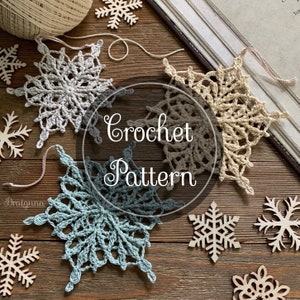 May include: Three crocheted snowflakes in white, beige, and blue on a wooden background. The snowflakes are arranged in a circle with the text "Crochet Pattern" in the center.