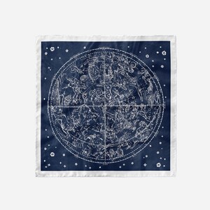 May include: A navy blue square bandana with a white constellation map printed on it. The map shows the constellations of the Northern Hemisphere. The bandana has a white border.