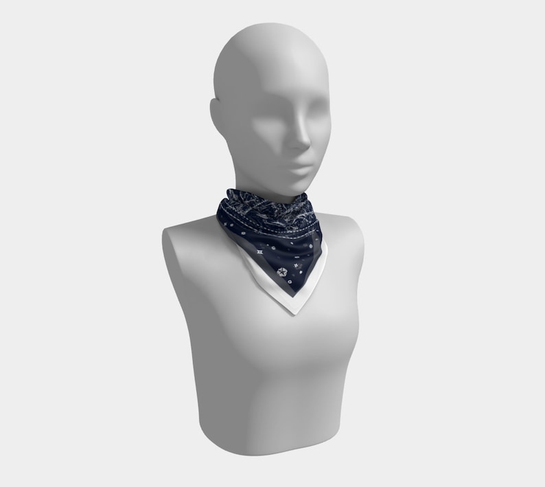 May include: A navy blue bandana with a white and gray pattern. The bandana is tied around the neck of a white mannequin.