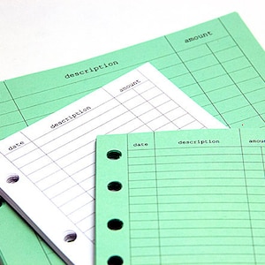 May include: Three green sheets of paper with holes on the left side. Each sheet has columns labeled "date", "description", and "amount".