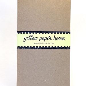 May include: A brown notebook with a yellow and black label that says "yellow paper house" and "yellowpaperhouse.etsy.com".