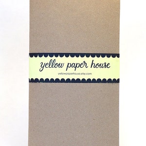 May include: A brown notebook with a yellow and black label that says "yellow paper house" and "yellowpaperhouse.etsy.com".