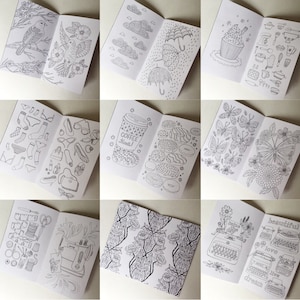 May include: Nine black and white illustrations of small, open books. Each book features a different design, including birds, clouds, umbrellas, a cupcake, coffee, doughnuts, butterflies, flowers, sewing supplies, and typewriters. The illustrations are drawn in a simple, whimsical style.