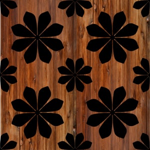 May include: A seamless pattern of black stylized flowers on a brown wood background.