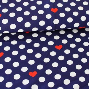 Könnte beinhalten: Marineblauer Stoff mit weißen Punkten und roten Herzen.