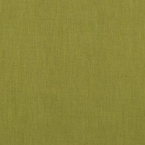 May include: A close-up of a textured, green fabric. The fabric has a subtle woven pattern.