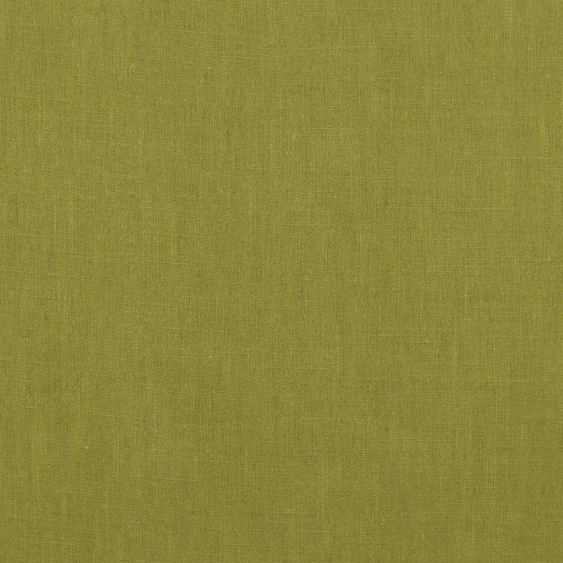 May include: A close-up of a textured, green fabric. The fabric has a subtle woven pattern.
