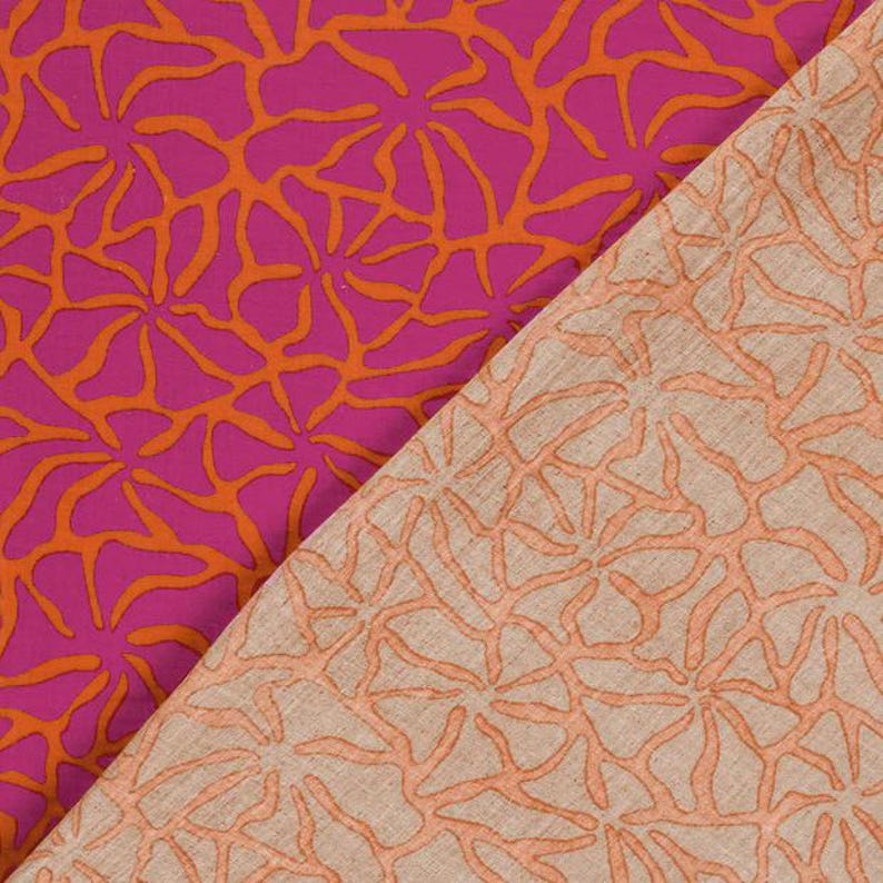 May include: Two fabric swatches with a repeating floral pattern. One swatch is a vibrant magenta with orange floral designs. The other is a beige fabric with the same orange floral pattern. The fabric has a textured appearance.