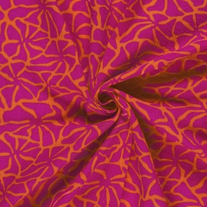 May include: Close-up of a vibrant fabric with a repeating floral pattern. The fabric features a bright fuchsia background with an overlay of orange, abstract floral shapes. The fabric is gathered, showing the texture and folds of the material.